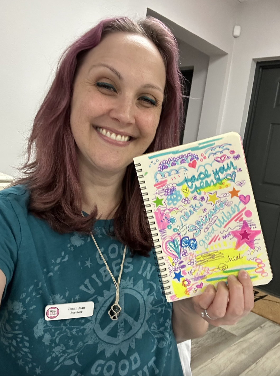 Susan Jean holding her art journal in Las Vegas